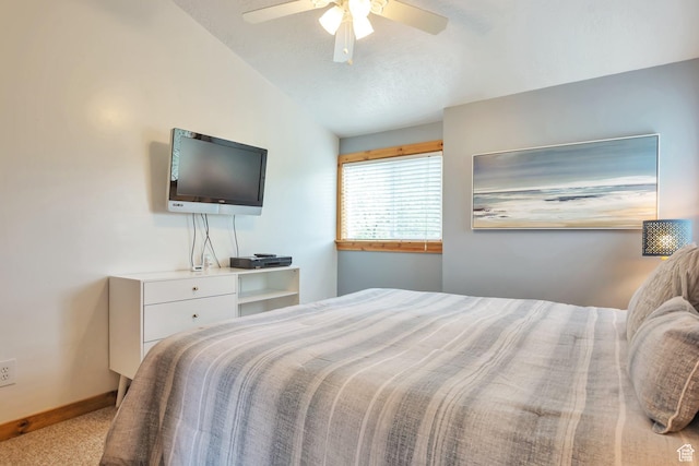 bedroom featuring lofted ceiling, carpet floors, baseboards, and ceiling fan