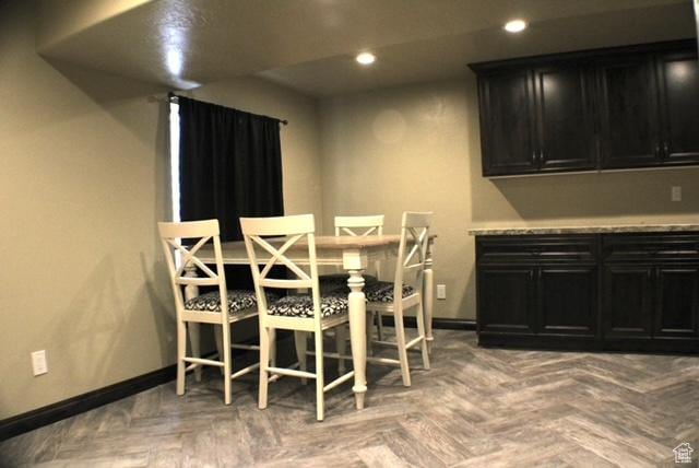 dining space featuring baseboards and recessed lighting