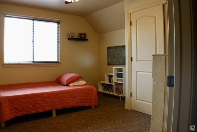 bedroom featuring carpet flooring, lofted ceiling, and ceiling fan