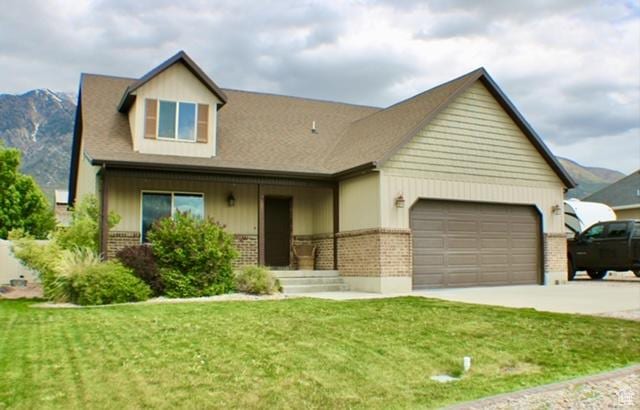 view of front of property featuring brick siding, an attached garage, driveway, and a front yard