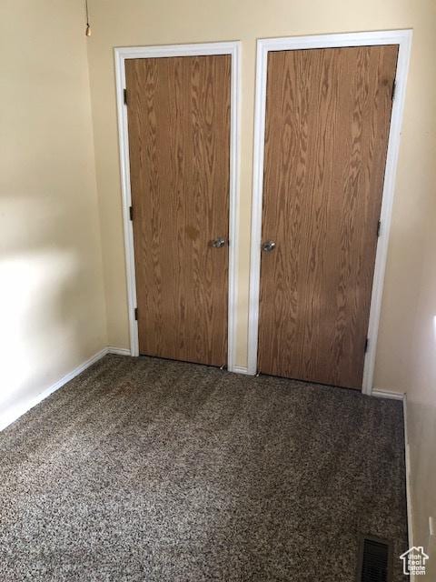 3923 W Rockwood Way Unit G, West Valley City, UT 84120 - unfurnished bedroom with two closets, carpet floors, and baseboards