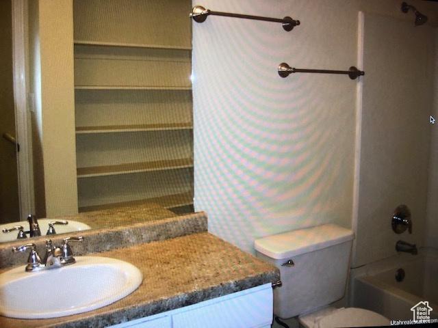 3923 W Rockwood Way Unit G, West Valley City, UT 84120 - bathroom featuring vanity, toilet, and bathtub / shower combination