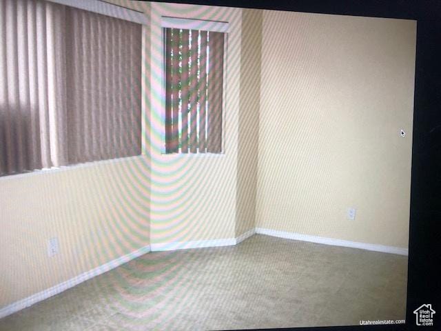 3923 W Rockwood Way Unit G, West Valley City, UT 84120 - spare room featuring baseboards and carpet flooring