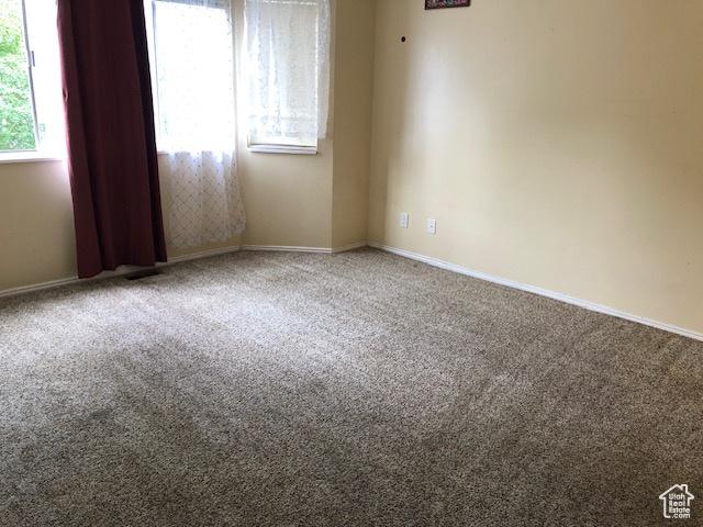 3923 W Rockwood Way Unit G, West Valley City, UT 84120 - carpeted spare room featuring baseboards