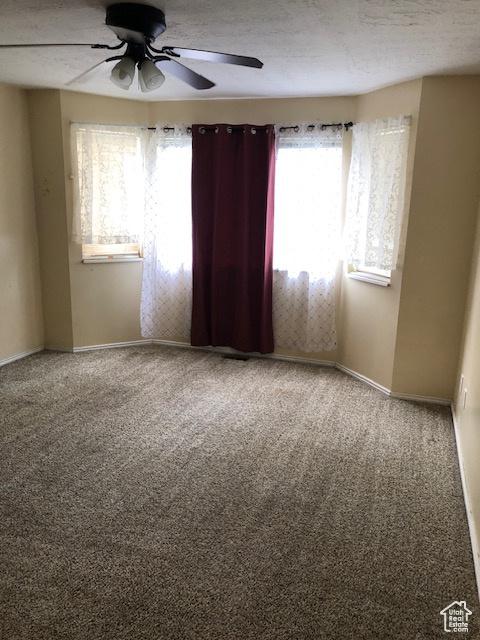 3923 W Rockwood Way Unit G, West Valley City, UT 84120 - spare room featuring a ceiling fan, carpet flooring, and baseboards