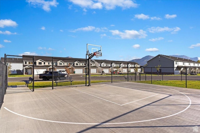 2085 W 1575th Ct S Unit 126, West Haven, UT 84401 - view of basketball court featuring a residential view, community basketball court, fence, and a mountain view