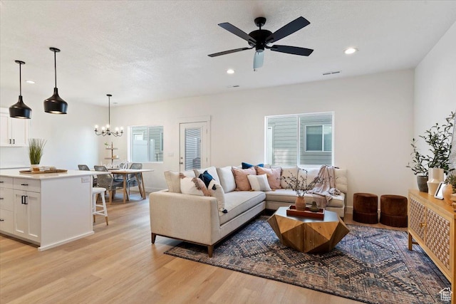 2085 W 1575th Ct S Unit 126, West Haven, UT 84401 - living area with light wood-style floors, recessed lighting, a ceiling fan, a chandelier, and a textured ceiling