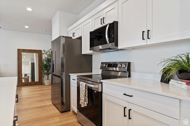 2085 W 1575th Ct S Unit 126, West Haven, UT 84401 - kitchen with appliances with stainless steel finishes, light countertops, white cabinetry, light wood finished floors, and recessed lighting