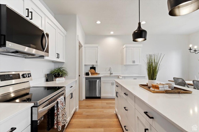 2085 W 1575th Ct S Unit 126, West Haven, UT 84401 - kitchen featuring stainless steel appliances, a sink, white cabinetry, light countertops, and recessed lighting