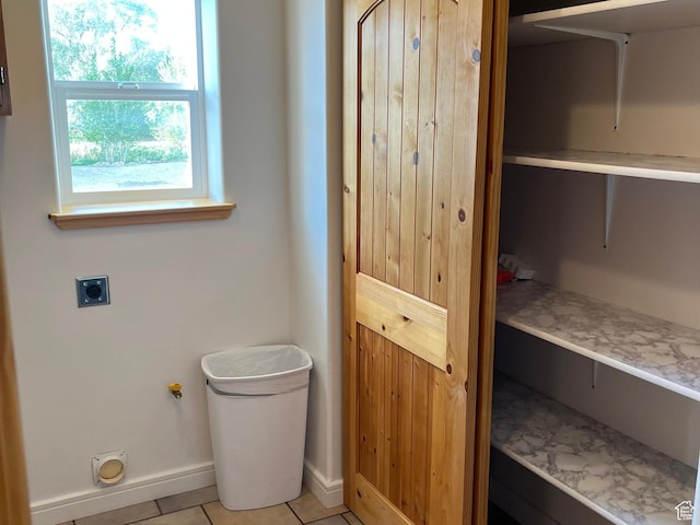 bathroom with baseboards and tile patterned floors