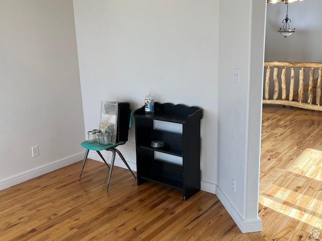 unfurnished room with hardwood / wood-style floors and baseboards