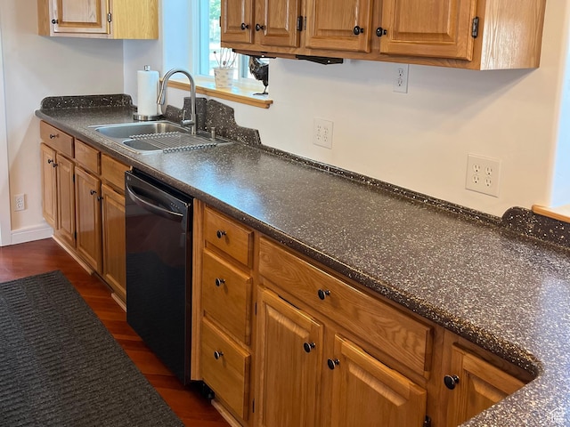 kitchen with dishwasher, a sink, dark countertops, dark wood-style flooring, and brown cabinetry
