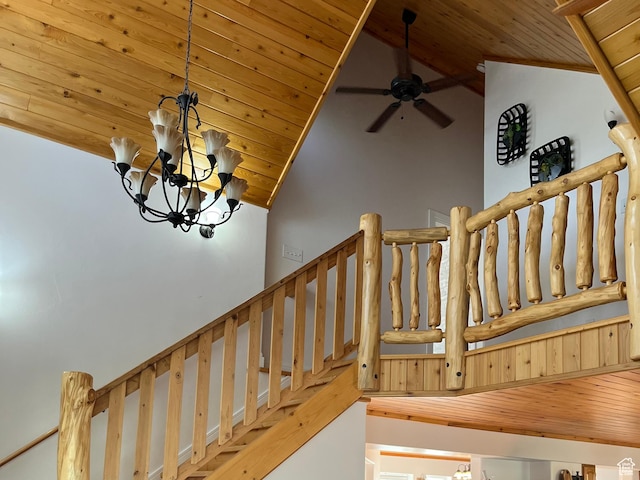 staircase with wooden ceiling, vaulted ceiling, ceiling fan, and a chandelier