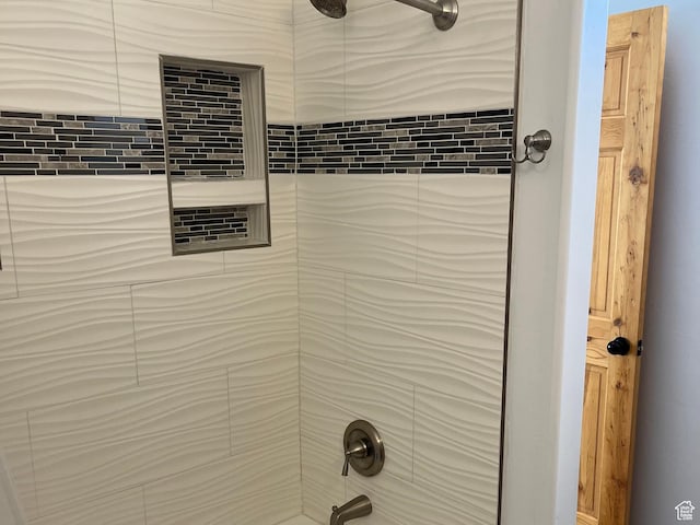 bathroom view of washtub / shower combination
