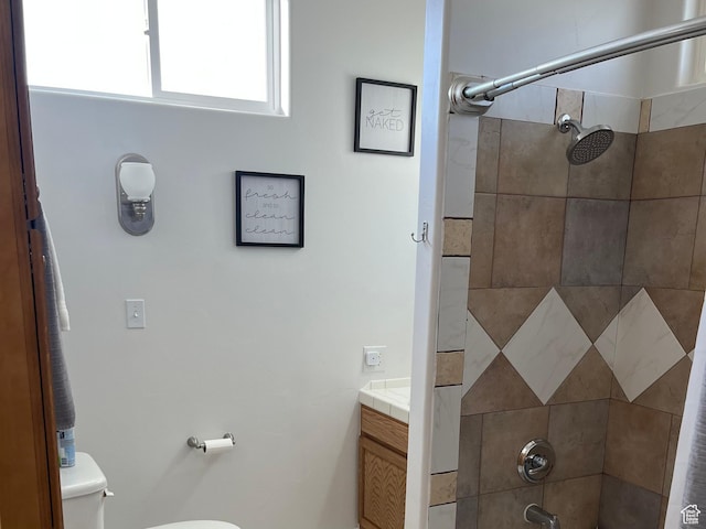 bathroom with toilet, vanity, and tub / shower combination
