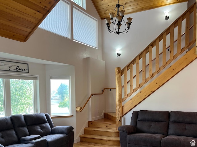 living room with stairway, wood ceiling, wood finished floors, a chandelier, and high vaulted ceiling