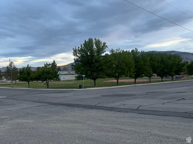 view of asphalt road with a mountain view