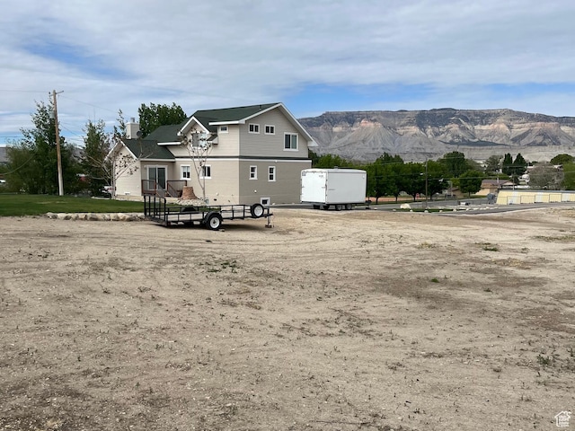 rear view of house with a mountain view and a chimney