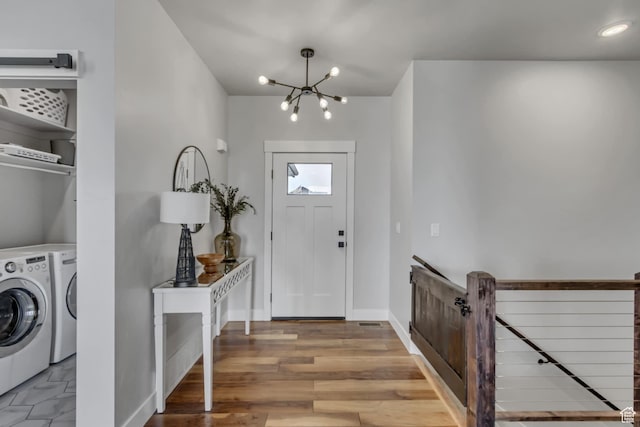 3537 S 5050 W, West Haven, UT 84401 - foyer entrance featuring separate washer and dryer, a chandelier, baseboards, and wood finished floors