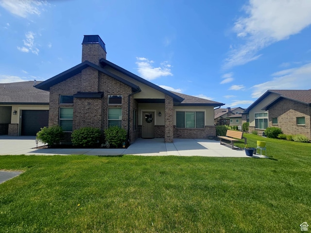 1704 W 300 S Unit Ud/L24, Mapleton, UT 84664 - rear view of property featuring brick siding, a chimney, a lawn, and roof with shingles