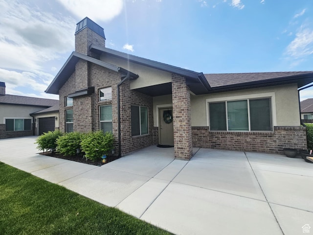 1704 W 300 S Unit Ud/L24, Mapleton, UT 84664 - rear view of house with stucco siding, a chimney, and brick siding