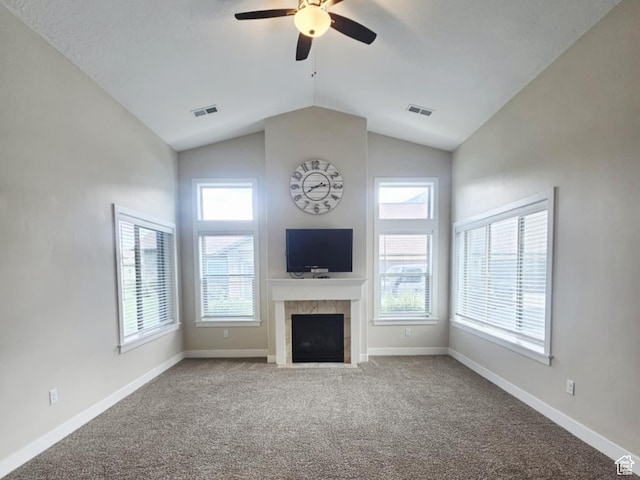 1704 W 300 S Unit Ud/L24, Mapleton, UT 84664 - unfurnished living room featuring a tiled fireplace, ceiling fan, vaulted ceiling, carpet floors, and healthy amount of natural light