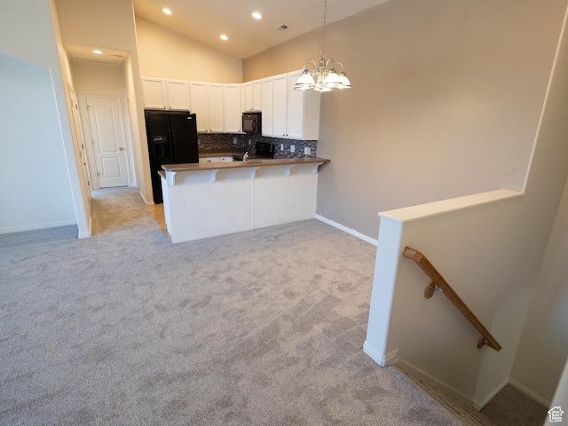 6324 S Traveler Ln W, West Jordan, UT 84081 - kitchen featuring black appliances, light colored carpet, decorative backsplash, lofted ceiling, and white cabinets