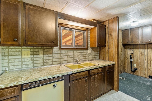 830 E Main St, Grantsville, UT 84029 - kitchen with white dishwasher, a sink, wood walls, light countertops, and decorative backsplash