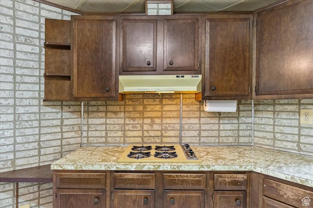 830 E Main St, Grantsville, UT 84029 - kitchen featuring under cabinet range hood, white cooktop, light countertops, and backsplash