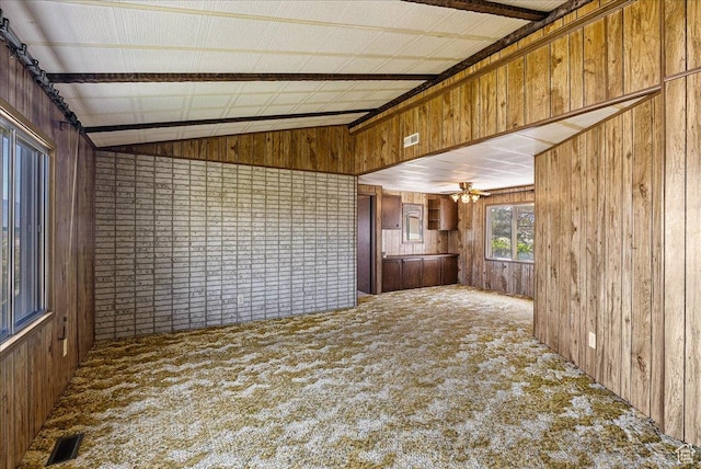 830 E Main St, Grantsville, UT 84029 - unfurnished living room featuring wood walls, carpet floors, vaulted ceiling, and ceiling fan