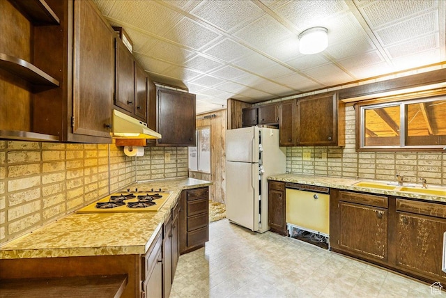 830 E Main St, Grantsville, UT 84029 - kitchen with white appliances, open shelves, under cabinet range hood, light countertops, and a sink