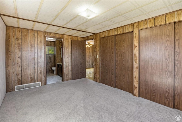 830 E Main St, Grantsville, UT 84029 - unfurnished bedroom featuring wood walls, carpet, two closets, and ensuite bathroom