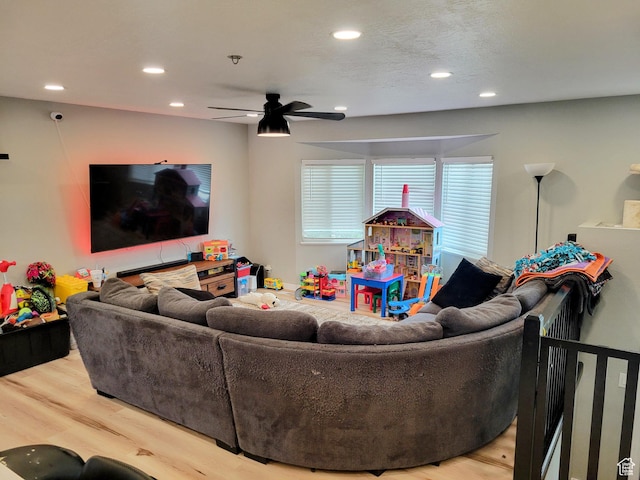 living area with recessed lighting, wood finished floors, and a ceiling fan