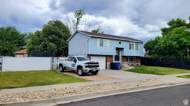 split foyer home with brick siding, concrete driveway, and a garage