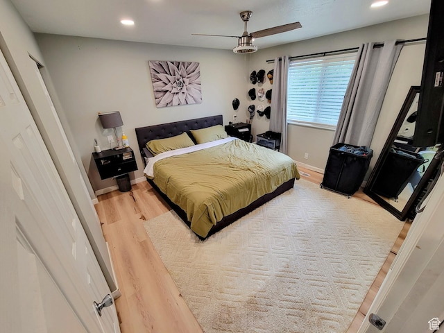 bedroom featuring wood finished floors, recessed lighting, baseboards, and ceiling fan