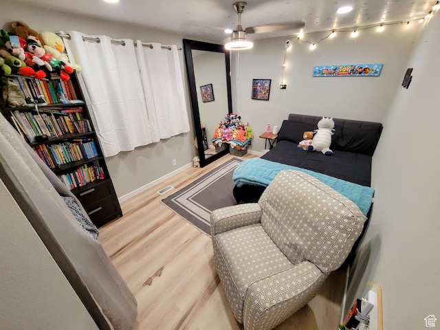 bedroom featuring wood finished floors and baseboards