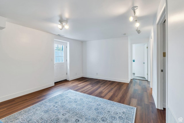 unfurnished room featuring dark wood finished floors and baseboards