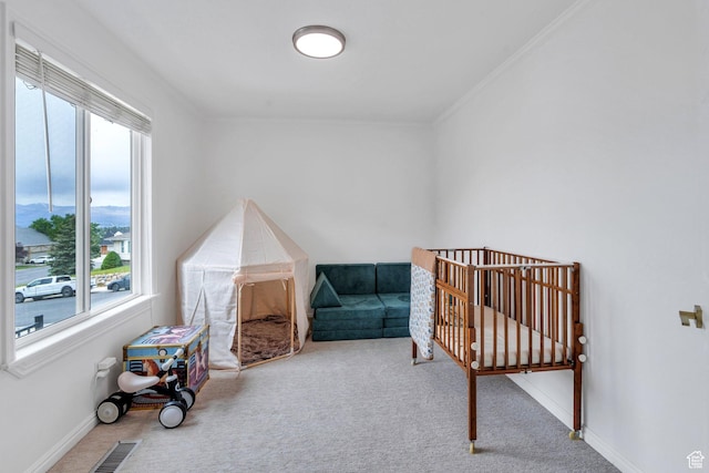bedroom with multiple windows, carpet floors, crown molding, and baseboards