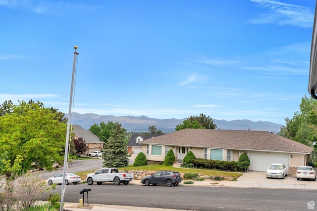 view of front of property featuring a mountain view, a garage, and concrete driveway