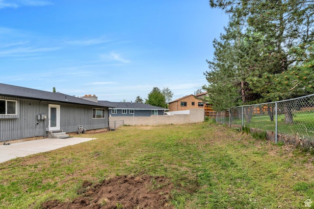 view of yard with entry steps and a patio area