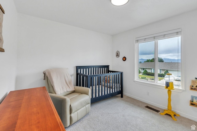 bedroom with carpet floors, multiple windows, baseboards, and a nursery area