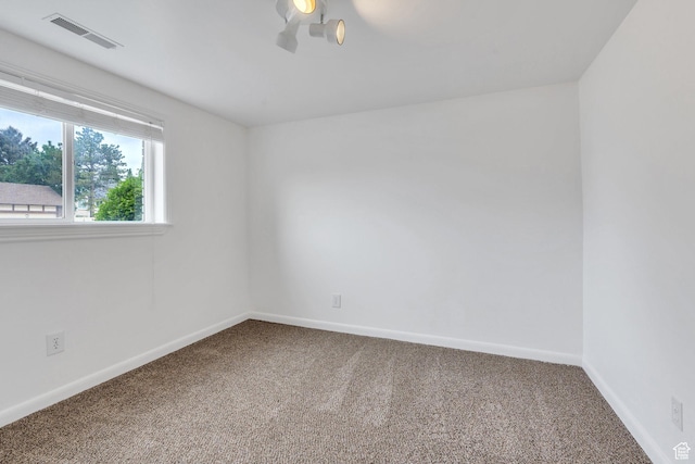 carpeted spare room with baseboards