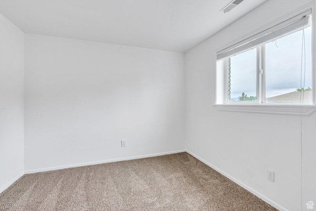 empty room with carpet and baseboards