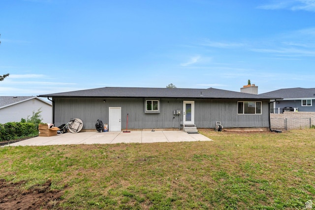 back of property featuring a patio area, entry steps, and a chimney