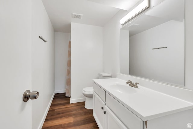 full bathroom featuring baseboards, wood finished floors, vanity, toilet, and curtained shower