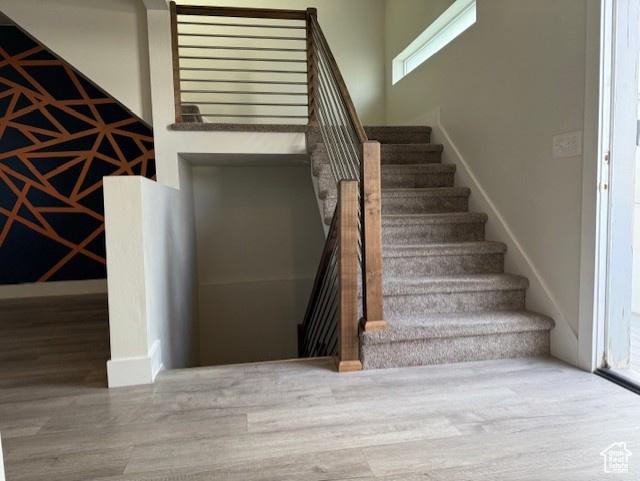 3586 S Xenon Dr, West Valley City, UT 84119 - stairway with wood finished floors and baseboards