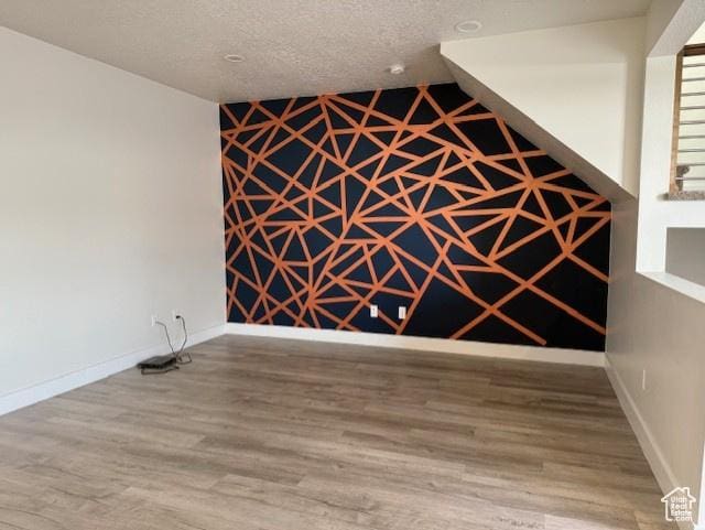 3586 S Xenon Dr, West Valley City, UT 84119 - empty room featuring wood finished floors, baseboards, and a textured ceiling