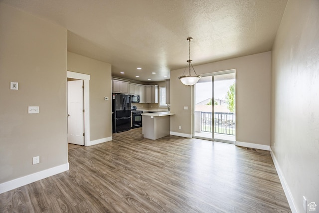 972 S High Ridge Rd, Spanish Fork, UT 84660 - kitchen featuring black appliances, light countertops, open floor plan, wood finished floors, and a textured ceiling