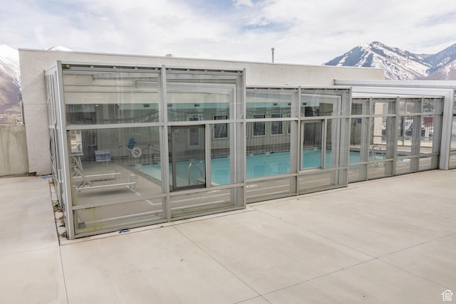972 S High Ridge Rd, Spanish Fork, UT 84660 - rear view of property with a community pool, a patio, a sunroom, and a mountain view