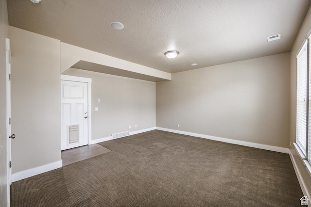 972 S High Ridge Rd, Spanish Fork, UT 84660 - unfurnished room with dark carpet, baseboards, a textured ceiling, and plenty of natural light